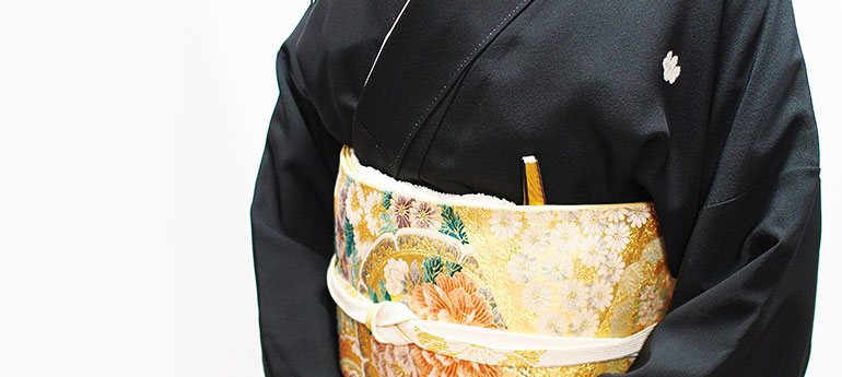 和装の結婚式に参加する女性が左胸側の帯と帯揚げの間に、祝儀扇（末広）を差しているイメージ画像